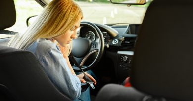 Student fastens seat belt in car, driving school