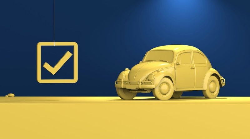 a yellow car parked in front of a blue wall
